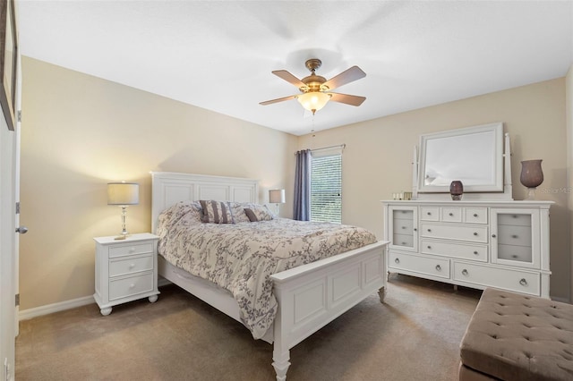 bedroom featuring dark colored carpet, a ceiling fan, and baseboards