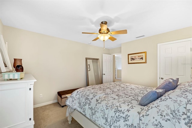 bedroom featuring baseboards, a ceiling fan, visible vents, and light colored carpet