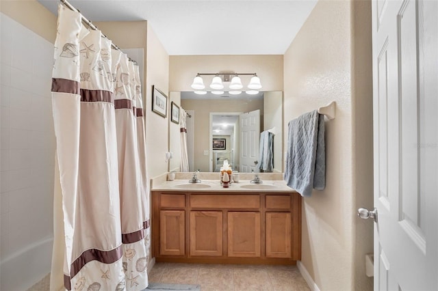 full bath with double vanity, a shower with shower curtain, a sink, and tile patterned floors