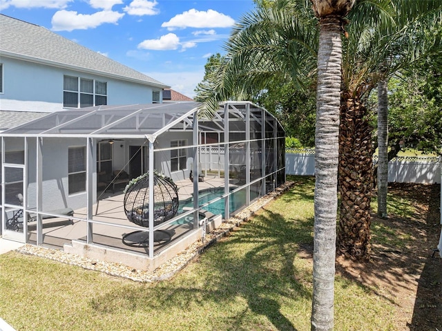 view of swimming pool featuring a lanai, a patio area, fence, and a lawn