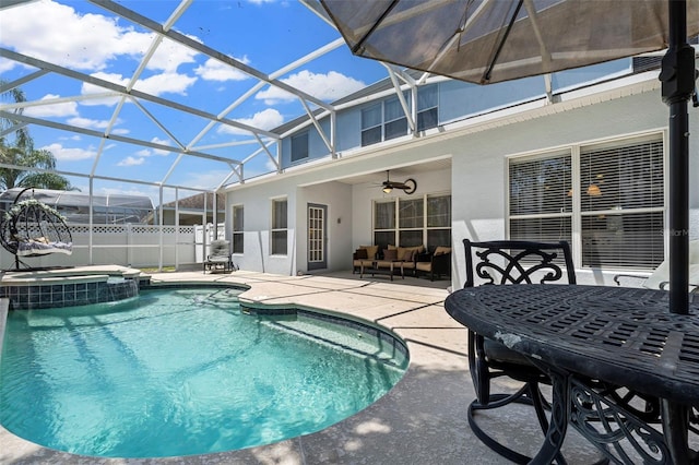 view of pool with a lanai, ceiling fan, outdoor lounge area, and a patio