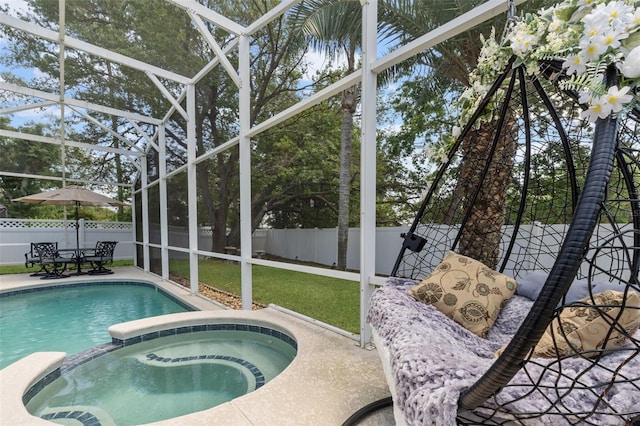 view of pool with a pool with connected hot tub, a lanai, a fenced backyard, and a patio