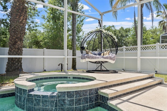 view of pool featuring an in ground hot tub and a fenced backyard