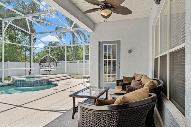 exterior space featuring glass enclosure, a fenced backyard, an outdoor living space, and a ceiling fan