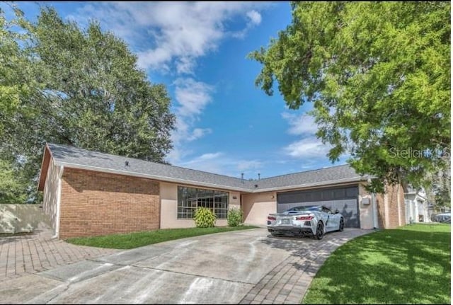 ranch-style house with driveway, a garage, a front lawn, and brick siding