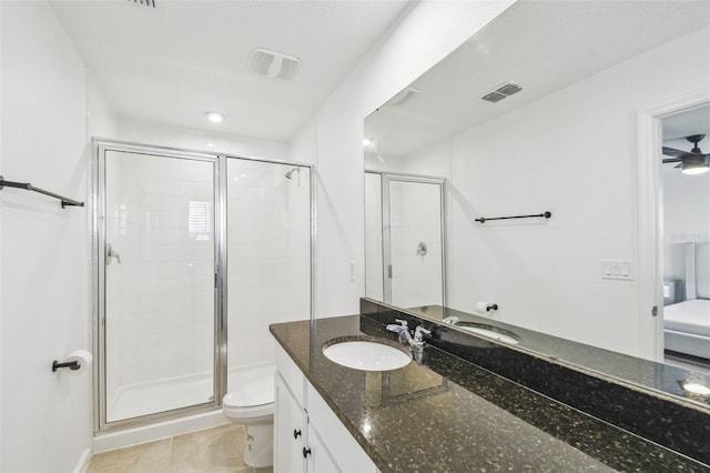 bathroom featuring visible vents, a shower stall, toilet, and vanity