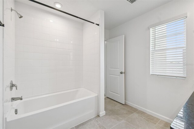 full bath featuring tile patterned flooring, baseboards, and shower / bathtub combination