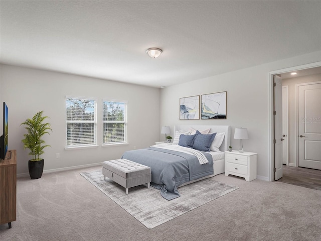 bedroom featuring carpet flooring and baseboards