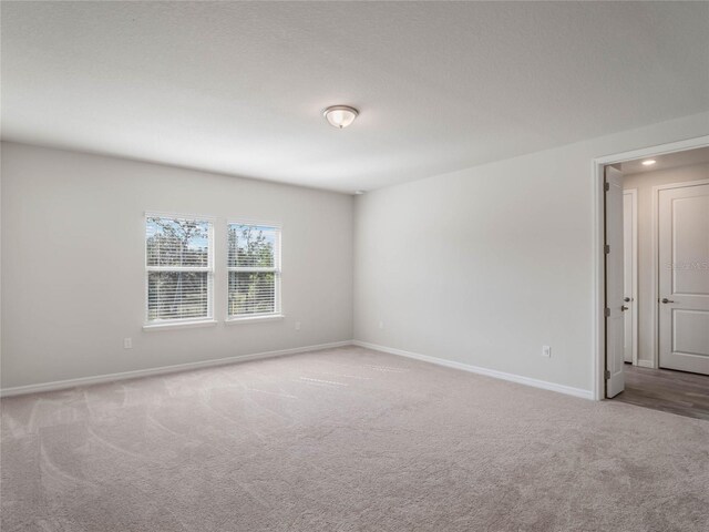 unfurnished room featuring recessed lighting, baseboards, and carpet floors