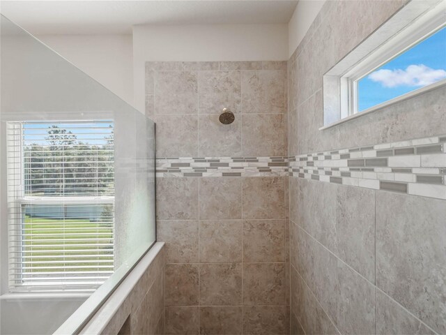 bathroom with a tile shower