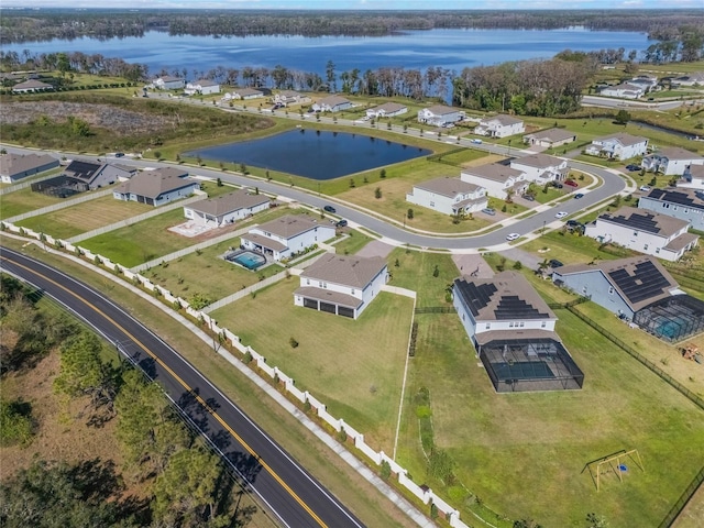 birds eye view of property featuring a water view and a residential view