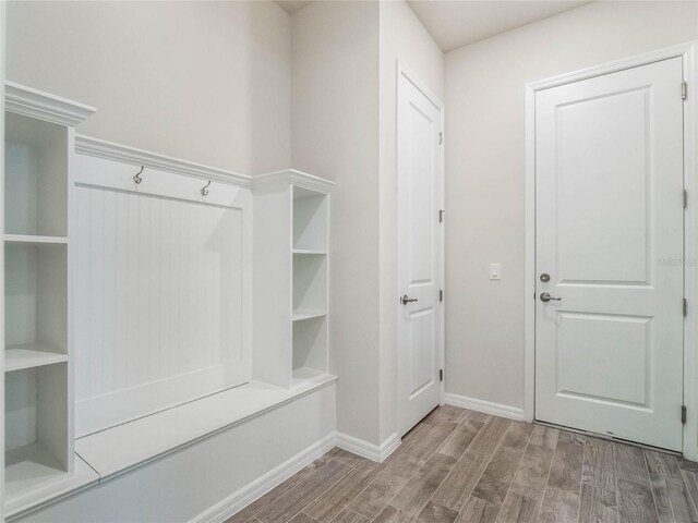 mudroom featuring baseboards and wood finished floors