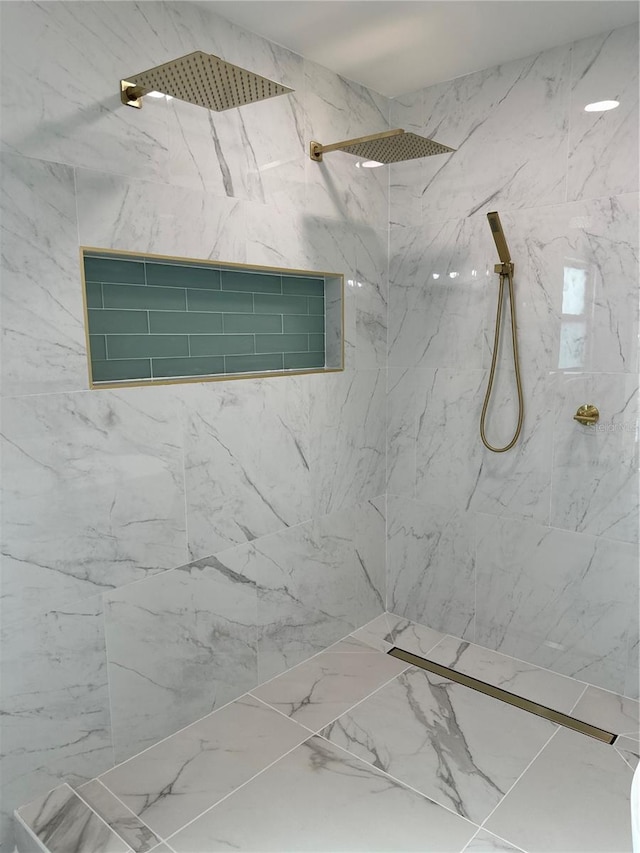 full bath featuring a marble finish shower