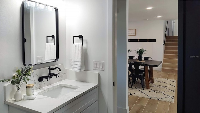 bathroom with recessed lighting, vanity, and wood tiled floor