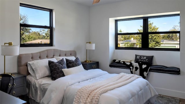 bedroom featuring multiple windows and baseboards