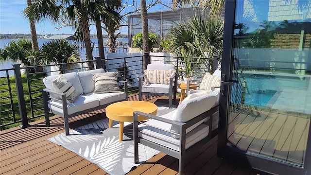 wooden deck with outdoor lounge area and a water view