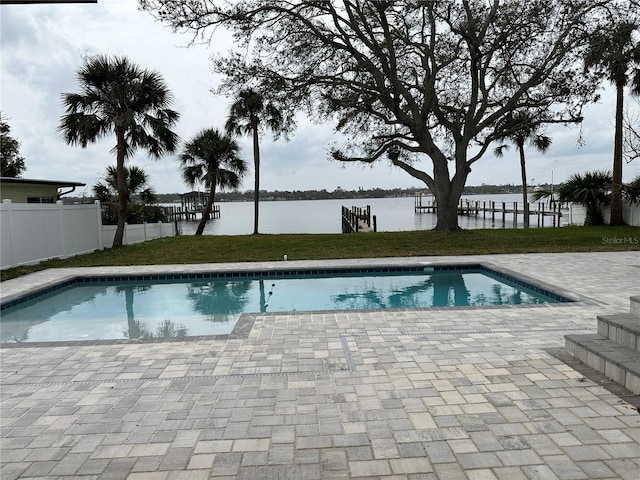 view of pool with a fenced in pool, fence, a patio, and a water view