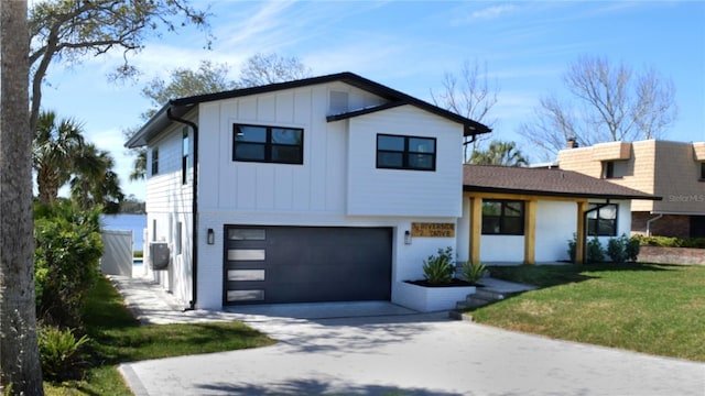 view of front of property featuring a front yard, driveway, a garage, board and batten siding, and brick siding