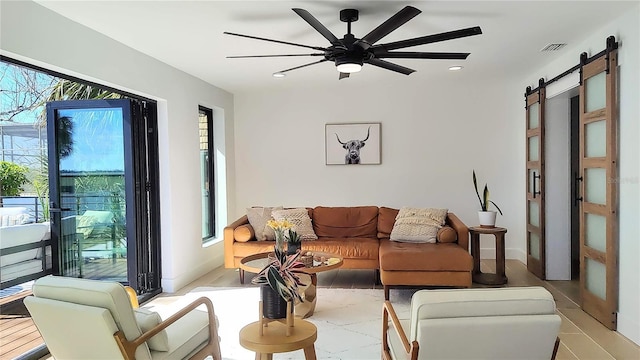 living area featuring recessed lighting, a barn door, visible vents, and a ceiling fan