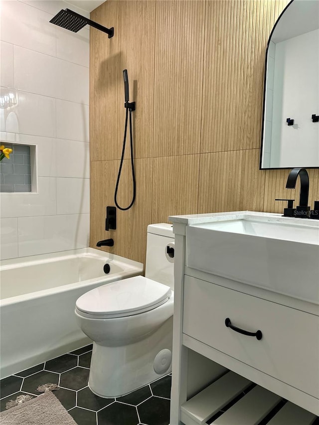 bathroom with vanity, tile patterned floors, toilet, and shower / bathing tub combination