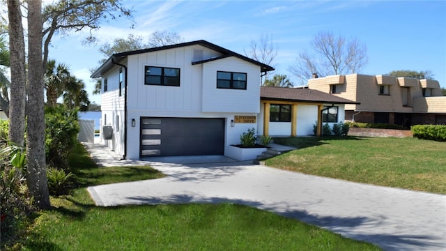 view of front facade with concrete driveway, an attached garage, board and batten siding, and a front yard