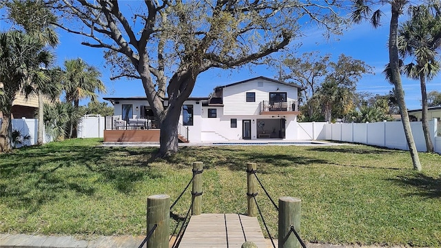 view of yard with a patio area, a wooden deck, and a fenced backyard