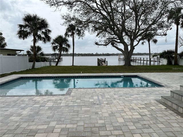 view of swimming pool featuring a patio, fence, a fenced in pool, and a water view