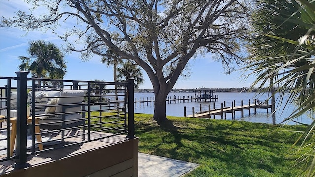 dock area featuring a yard and a water view