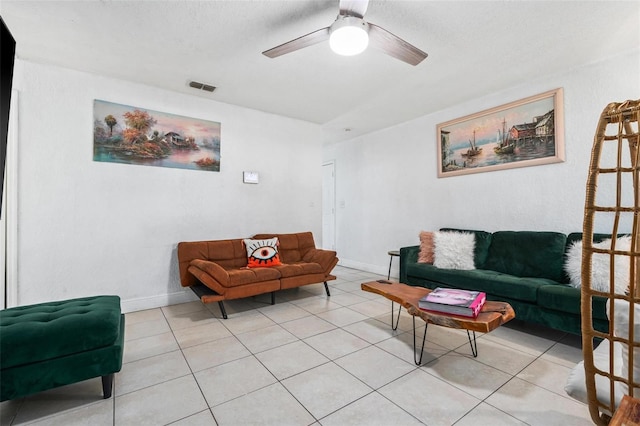 living area with baseboards, visible vents, a ceiling fan, and light tile patterned flooring