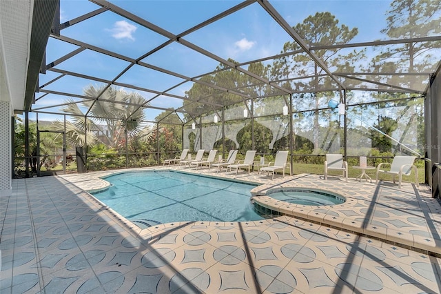 view of pool featuring a patio area, a lanai, and a pool with connected hot tub