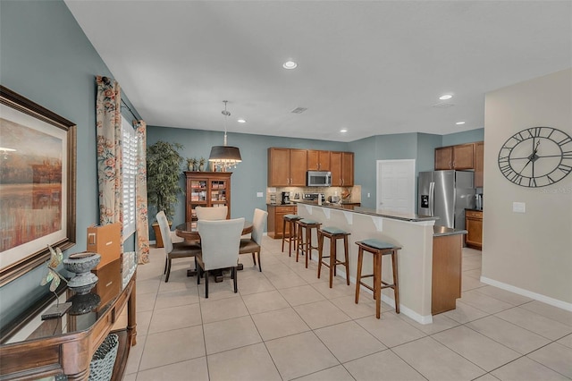 dining space with recessed lighting, baseboards, and light tile patterned floors