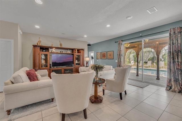 living area with recessed lighting, visible vents, and light tile patterned floors