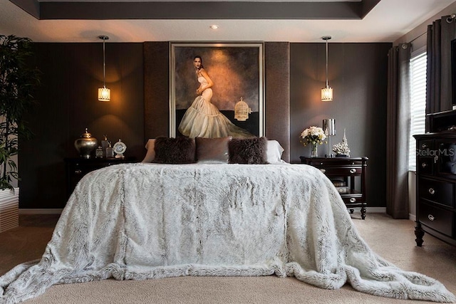 bedroom featuring carpet, baseboards, and a raised ceiling