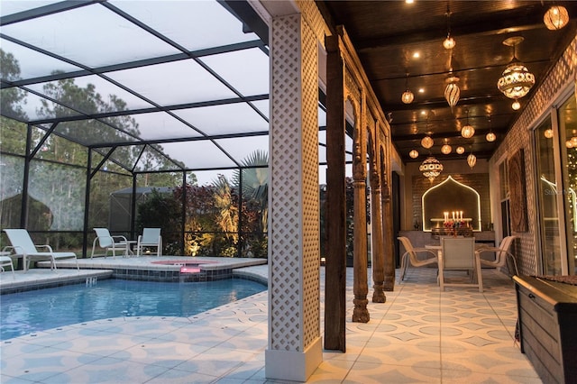 view of swimming pool featuring a patio, glass enclosure, a fireplace, and a pool with connected hot tub