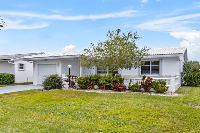 ranch-style house with a front lawn, a tiled roof, an attached garage, and stucco siding