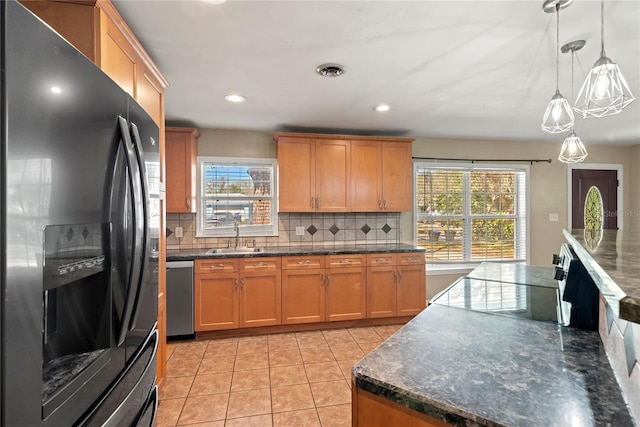 kitchen featuring light tile patterned floors, tasteful backsplash, dishwasher, and black fridge with ice dispenser