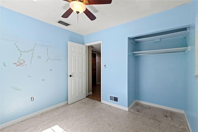 unfurnished bedroom with carpet floors, baseboards, visible vents, and a closet