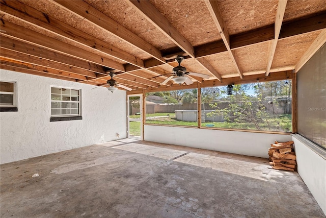 unfurnished sunroom featuring ceiling fan