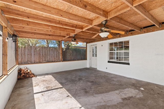 view of patio featuring ceiling fan and fence