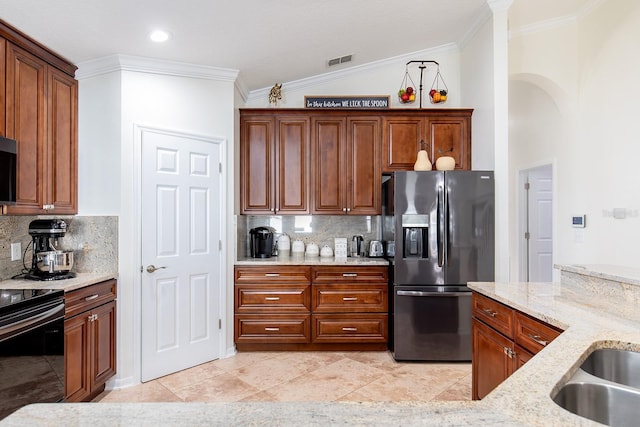 kitchen featuring visible vents, light stone countertops, crown molding, black range with electric cooktop, and stainless steel refrigerator with ice dispenser