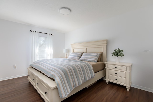 bedroom featuring dark wood-type flooring and baseboards