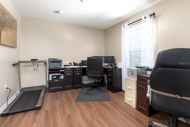 office space with a textured ceiling and wood finished floors