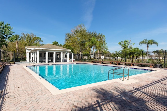 community pool featuring a patio and fence