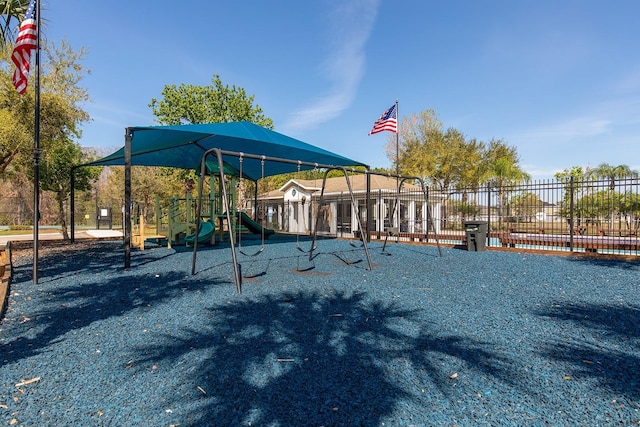 exterior space featuring playground community and fence