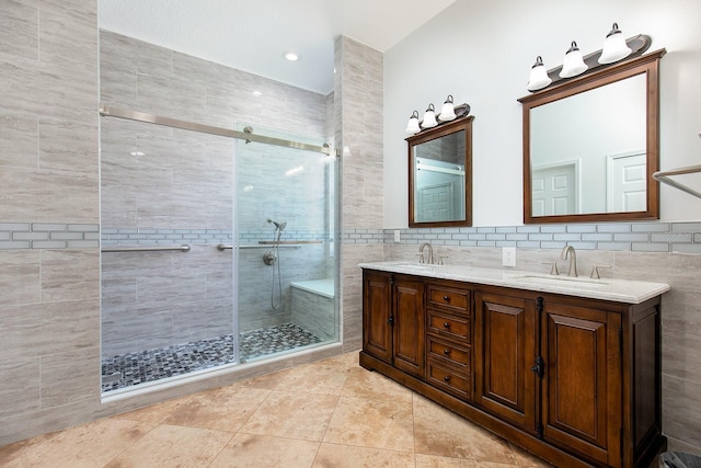 bathroom featuring a sink, a shower stall, and double vanity