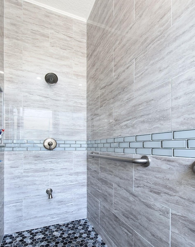 bathroom with tiled shower