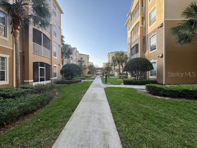 view of property's community featuring a lawn and a residential view
