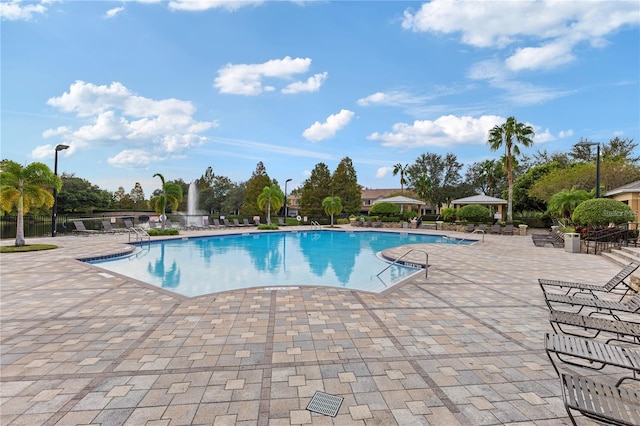 pool featuring a gazebo, fence, and a patio area