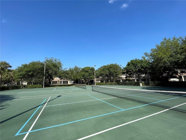 view of tennis court featuring community basketball court