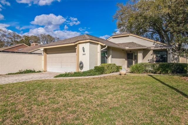 ranch-style home featuring a garage, decorative driveway, a front yard, and stucco siding